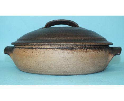 Richard Batterham (b. 1936), a shallow casserole dish and cover in dark brown glaze, 32cm diameter. 