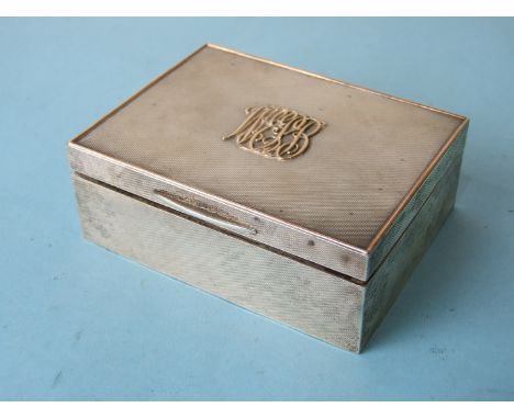 An Asprey engine-turned cigarette case with gold-lined top, applied with initials, Chester 1914, 12cm. 