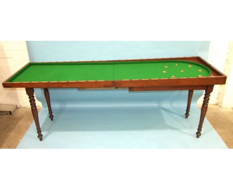 An early-19th century mahogany bagatelle table, the folding top and baize lined interior with numbered wood cups within the i