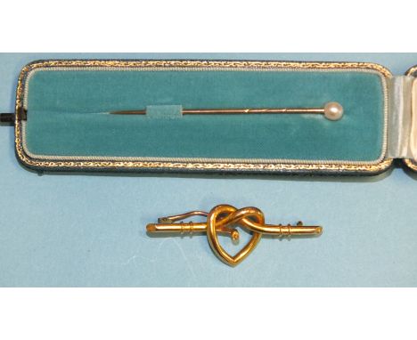 A pearl-topped gold stick pin in fitted case and a lover's knot brooch with central screw fitting, (pearl or gem missing), 3.