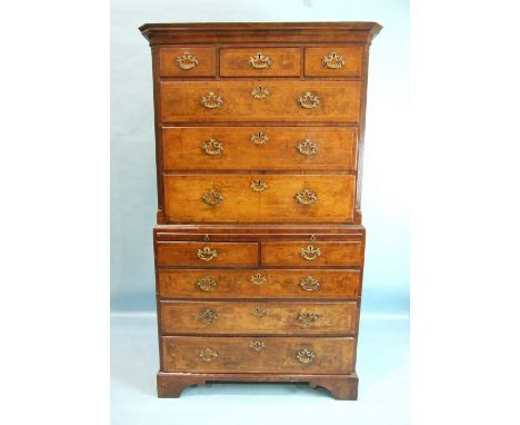 A George II walnut chest on chest, the cornice above three&nbsp;small and three long feather-banded drawers, within reeded bo