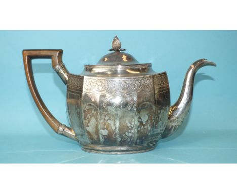 A George III rectangular teapot with oval lid, pineapple finial and wood handle, decorated overall with bright-cut foliate en