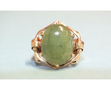 A jade ring claw-set green jade cabochon, in rose gold mount, marked '15k', size L, 7.8g. 