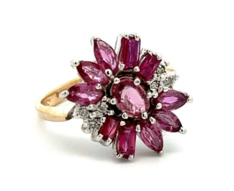 A 9ct gold ruby and diamond cluster ring. An oval ruby surrounded by marquise and baguette cut rubies with diamond accents. B