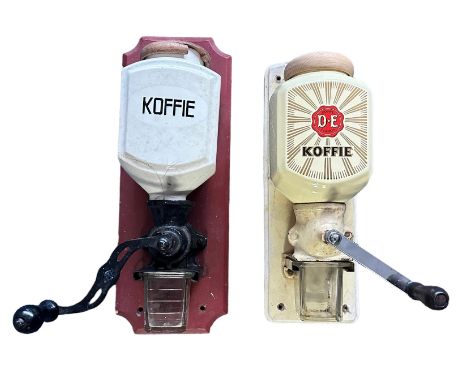 2x Vintage Douwe Egberts coffee grinders. 1 white porcelain coffee grinder, with Koffie printed on front. Mounted on a wooden