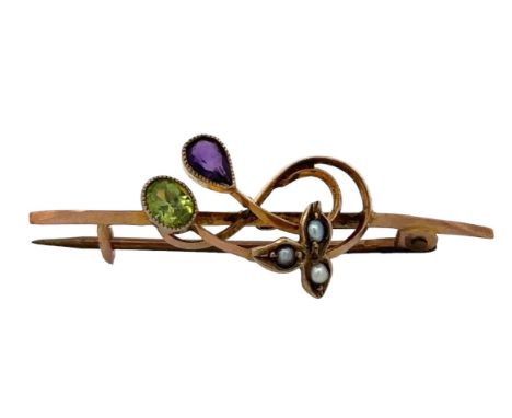 A peridot, amethyst and seed pearl bar brooch, stamped 9ct, 4cm in length. Weight 2.2g Please see the buyer's terms and condi