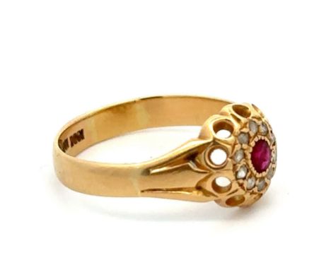 A gold and ruby ring with facetetd diamond accents in cluster style, stamped 18ct. Size P. Total weight 3.44g. Please see the