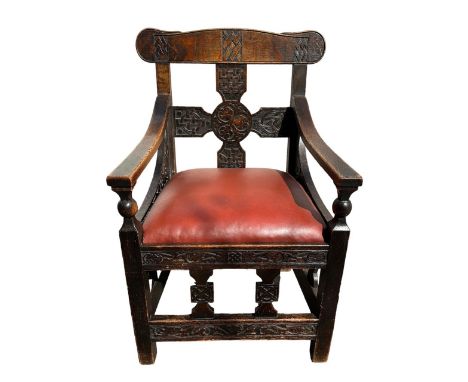 An interesting arts and crafts oak arm chair with a Celtic design, measures 58cm by 58cm by height 92cm. 