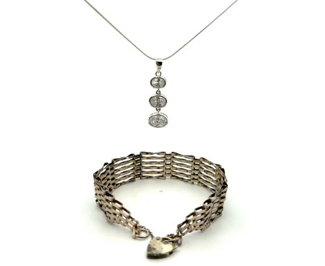 A CZ pendant on a 925 chain, weight 6g. Also a gate link bracelet with hallmarks on padlock and on one of the links, weight 1