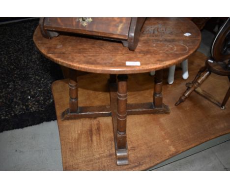 An early 20th century oak occasional table having circular top and ring turned legs and cross stretchers, w 60cm