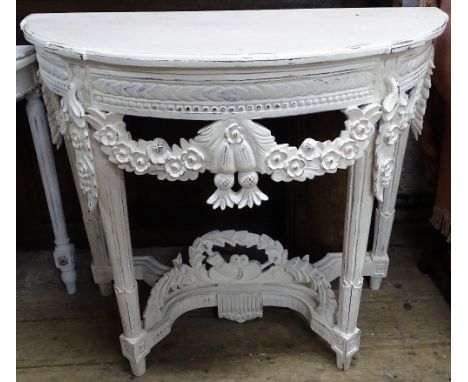 A decorative white painted demilune console table, with floral carved frieze and fluted legs, W97cm, H82cm 