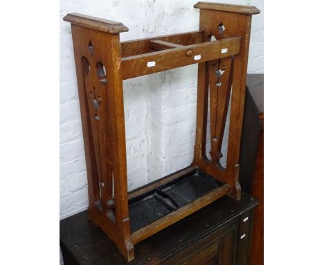 An Arts and Crafts oak stick stand, with stylised pierced sides, W54cm, H71cm 