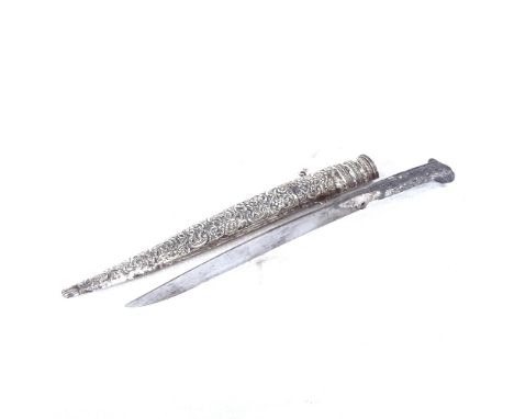 An Eastern dagger with white metal hilt and embossed white metal scabbard, length 44cm 
