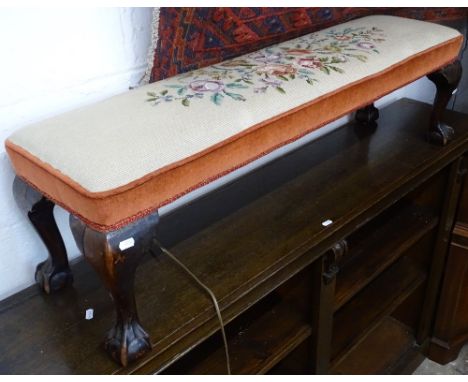 An Edwardian tapestry upholstered fender stool, on claw and ball feet, L110cm 