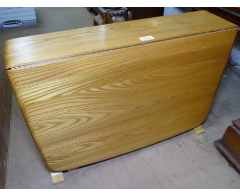 A modern Ercol drop leaf table, W67cm 