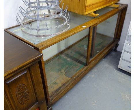 A Vintage glass and oak-framed shop display cabinet, with sliding glazed door, on cabriole feet, W178cm, H91cm, D59cm 