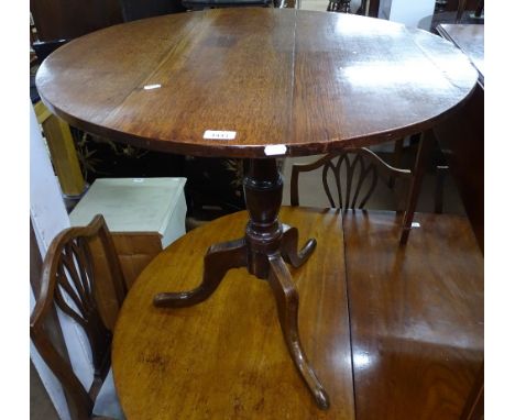 An Antique oak tilt-top table on tripod base, W80cm, H76cm 