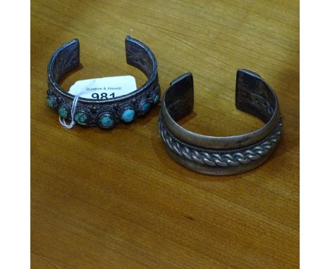 A heavy Egyptian silver bangle, and a Tibetan silver and turquoise set bangle (2) 