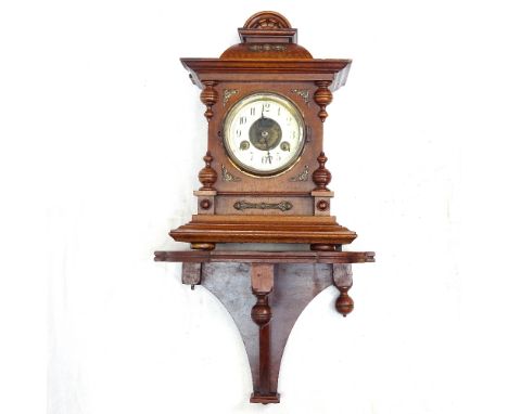 A carved oak-cased 2-train clock, height 35cm, and a mahogany bracket 