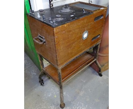A Vintage teak-cased "The Genito-Urinary" machine, by MFG &amp; Company Ltd London, W59cm 