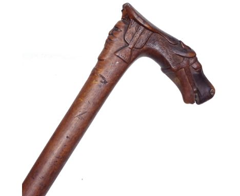 An Oriental walking stick with carved horse-head handle and mask decoration, length 92cm 