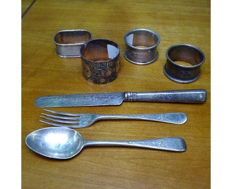 4 silver napkin rings, an engraved silver fork and spoon and knife set 