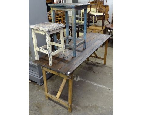 A stained pine plank-top folding tressel table, L176cm, a Vintage painted pine stool, and a side table 