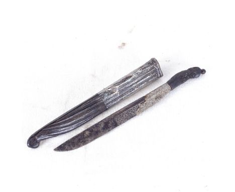 An Eastern dagger with engraved white metal mount, in silvered scabbard, length 26.5cm 