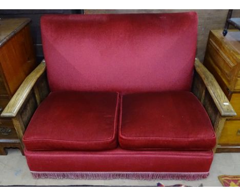 A 1930s 2-seater sofa with linen fold carved oak side panels, W122cm 