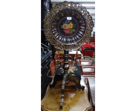 A delicate decorative Victorian papier mache and ebonised tilt-top table, having a carved and pierced dish-top, on a turned c