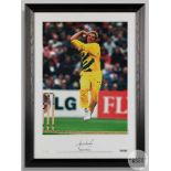 A large colour signed photographic print of Shane Warne bowling