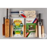 A collection of nine miniature cricket bats
