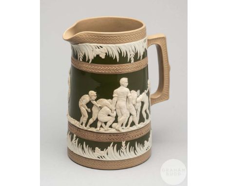 A large Copeland late Spode stoneware jug, decorated with rugby scenes, moulded in white raised relief between grassy borders