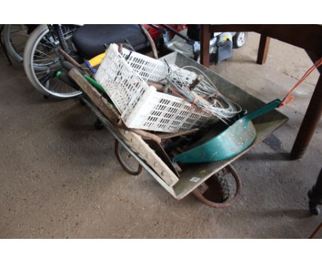 A wheelbarrow and contents of various tools 