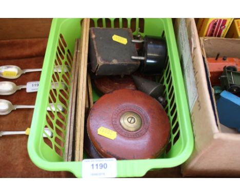 A tub containing various measuring tools; leather case measuring tape; plumbing bobs etc. 