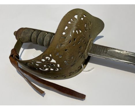 A George V 1897 pattern officer's sword, pierced basket hilt with cypher and wired shagreen grip joining an etched tapering b