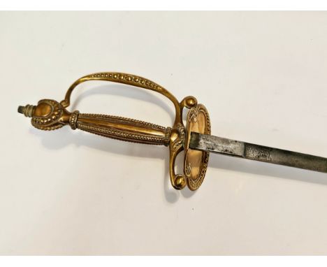 A George V court dress sword, brass hilt with D-form knucklebow and shell-form guard, joining an engraved fine tapering blade