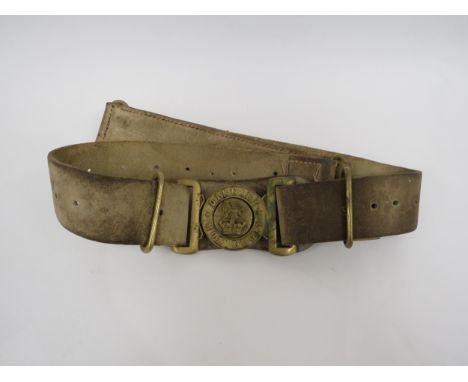 A Victorian British Army brass waist belt clasp on an original buff white leather belt