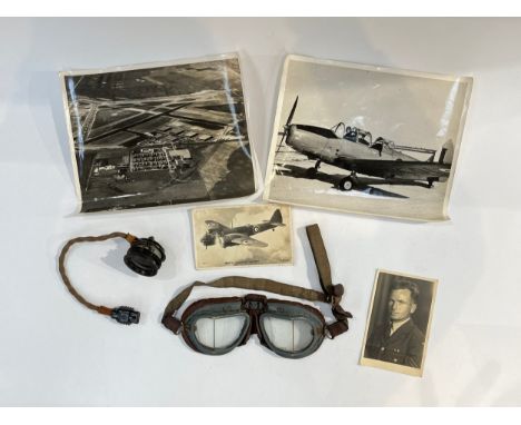 A pair of WWII flying goggles together with aircraft photograph, ephemera and flying helmet microphone