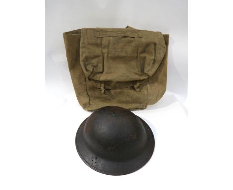 A WWII British Army helmet dated 1941, together with a WWII webbing kit bag (2)