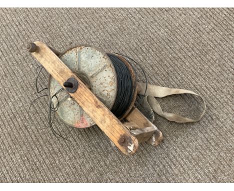 A circa 1952 British Army cable reel with webbing and tool