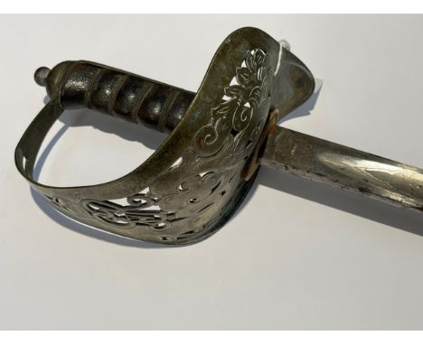 A George V 1897 pattern officer's sword, pierced basket hilt stamped with 'PRESENTED TO LIEUT. T.C. PERRY BY THE STUDENTS OF 