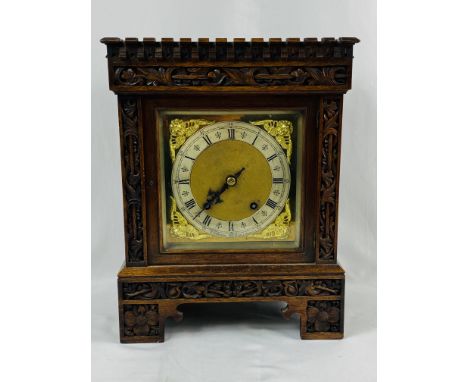 Oak cased mantel clock with brass face and brushed metal chapter ring, written E .H Mason, Middlesbrough, with pendulum and b