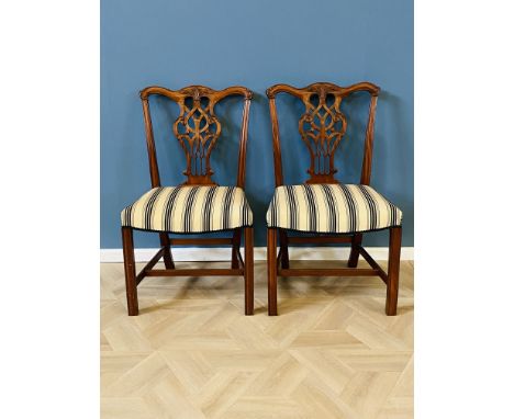 Pair of mahogany Chippendale style side chairs with carved ribbon back splats with overstuffed seats raised upon carved squar