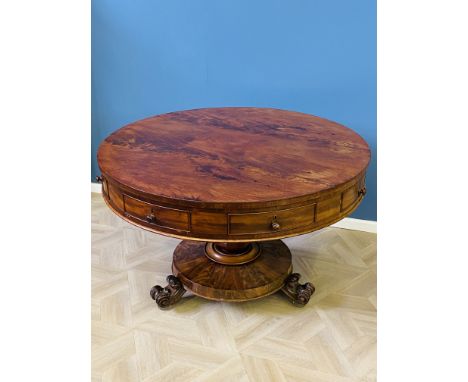 Early Victorian figured mahogany circular drum table with four opening drawers and four faux drawers, raised upon a faceted b