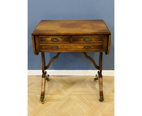 Inlaid mahogany three drawer sofa table with drop leaves to each end, with a shaped cross stretcher and swept legs to brass t