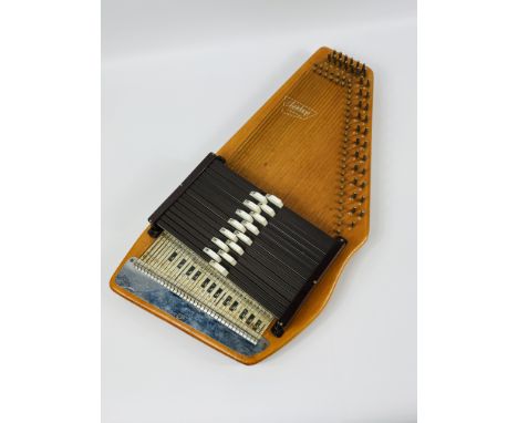 Autoharp by Oscar Schmitt in carry case with owners manual. Estimate £20-40.