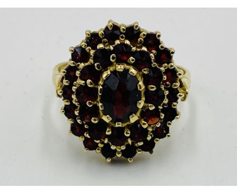 Yellow metal and red stone ring marked 900 RSG, 4.7g, size O. Estimate: £90-120