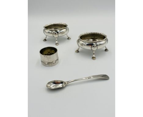 Two silver salts and a silver spoon, 193g; together with a silver napkin ring marked 800, 12g. Estimate: £100-120