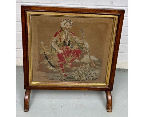 A 19TH CENTURY FIRE SCREEN WITH NEEDLEPOINT DEPICTION OF A YOUNG GENTLEMAN WEARING A TURBAN WITH A SWORD AND GUN, 57cm x 50cm